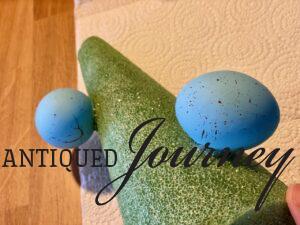 gluing Easter eggs on topiary cone