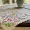 a thrifted table linen with embroidered flowers