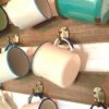 a collection of vintage enamelware cups