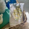 a vintage linen napkin with yellow flowers in a summer vignette