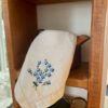 a vintage embroidered hanky displayed in vintage copper